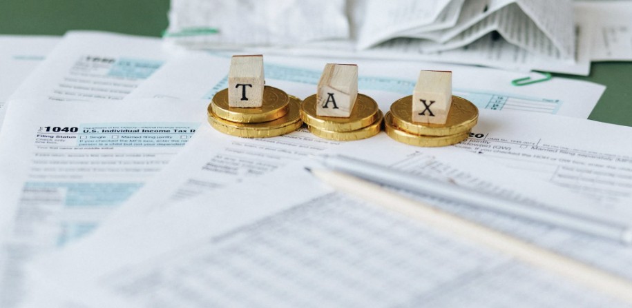 Tax planning files stacked with coins